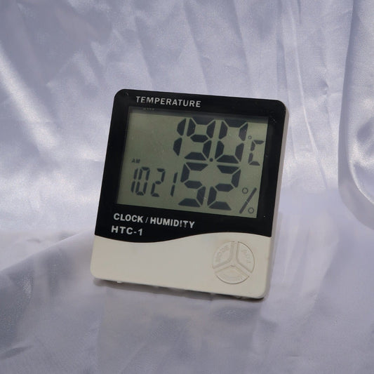 Digital beauty room thermometer and hygrometer displaying temperature and humidity levels.