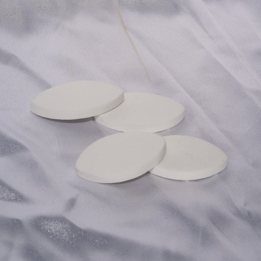 White lash extension practice sponges arranged in an overlapping group.