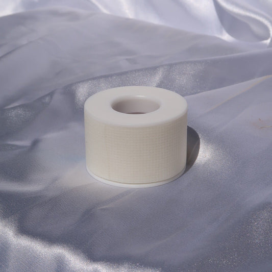 Single roll of white sensitive lash tape for lash extension application.